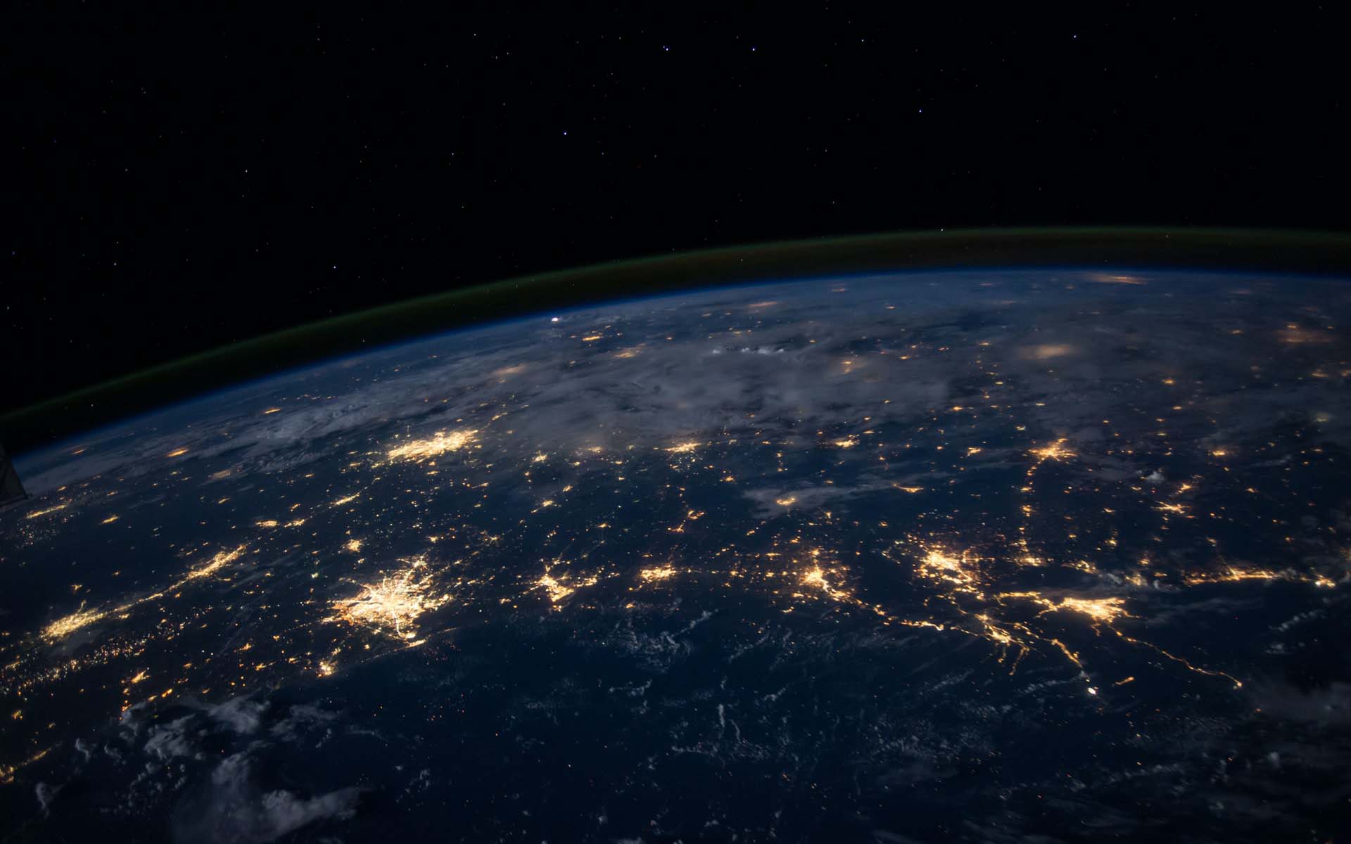 view of earth from space darkened with lights