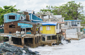 House falling into the ocean as a result of a Hurricane Maria.