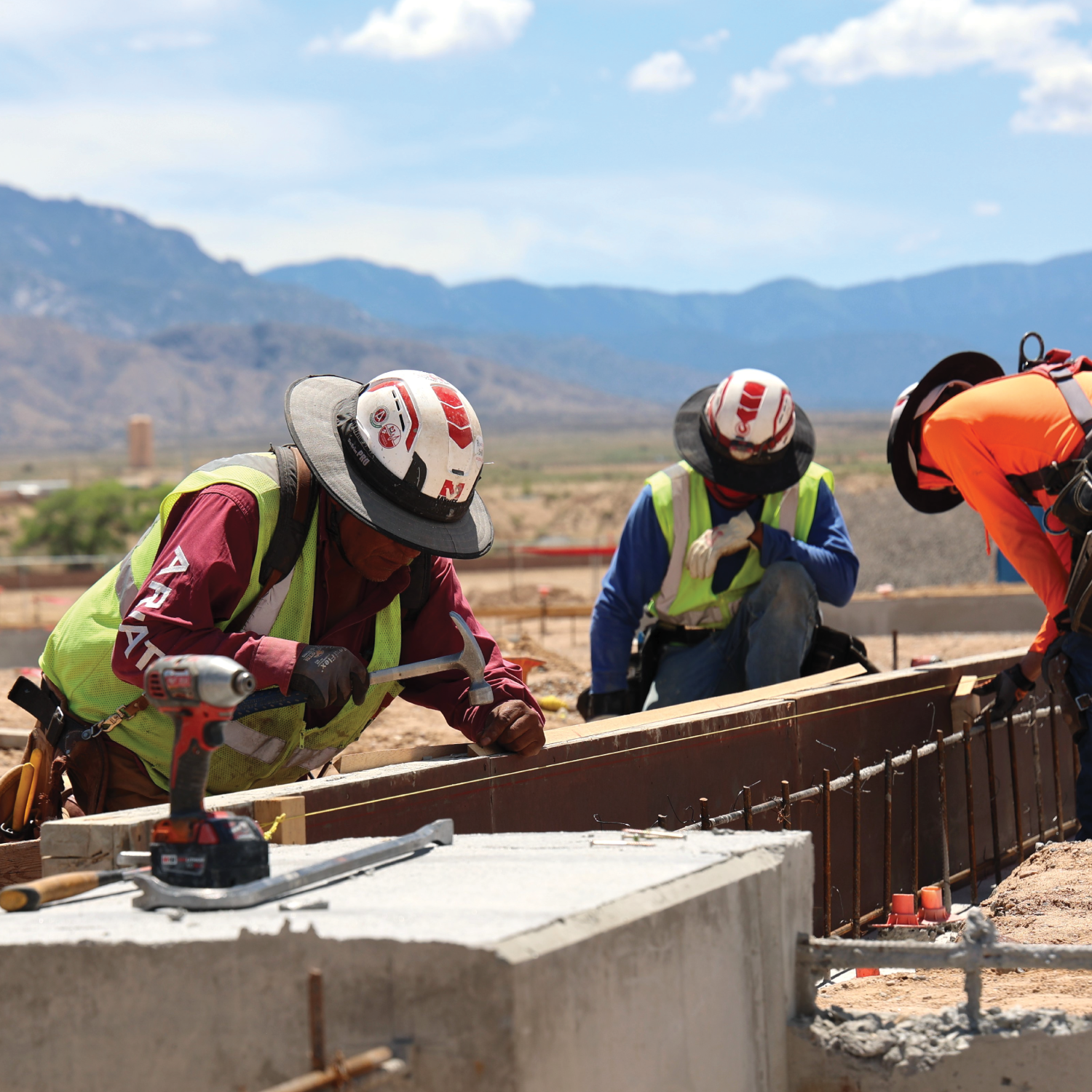 Workers hammering nails